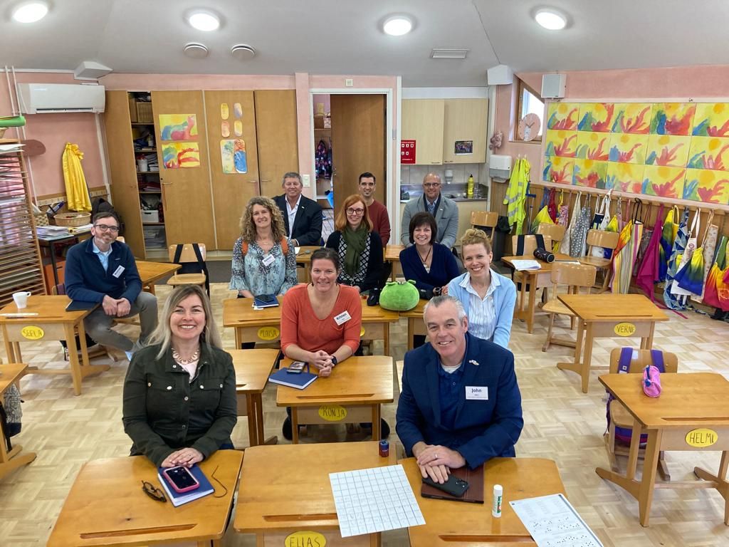 A group of U.S. school administrators is shown seated in an elementary classroom in Finland during a Fulbright Finland Foundation cultural exchange trip.